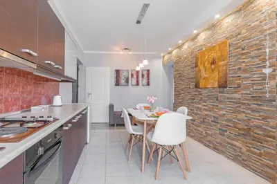 a kitchen with a table and a brick wall at 3- Sea view luxury suite in the center of Rhodes! in Rhodes Town