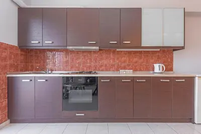 a kitchen with brown cabinets and an oven at 3- Sea view luxury suite in the center of Rhodes! in Rhodes Town