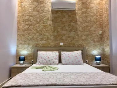 a bedroom with a bed with two night stands at 6-Stylish mini-suite for 4 people in central Rhodes! in Rhodes Town