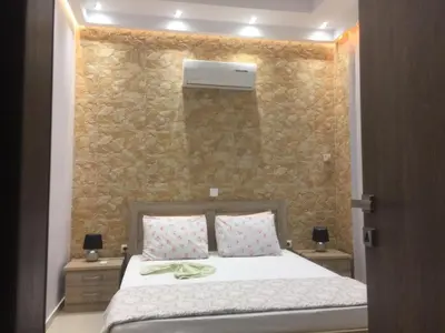 a bedroom with a bed and a stone wall at 6-Stylish mini-suite for 4 people in central Rhodes! in Rhodes Town