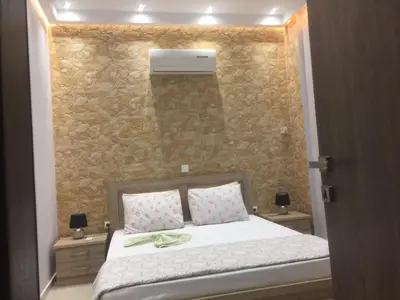 a bedroom with a bed with a stone wall at 6-Stylish mini-suite for 4 people in central Rhodes! in Rhodes Town