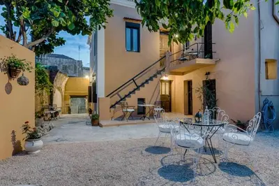 a patio with a table and chairs in a courtyard at Kristina´s Apartments in Rhodes Town