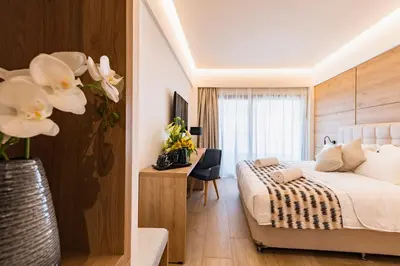 a bedroom with a bed and a desk in a room at Acandia Hotel in Rhodes Town
