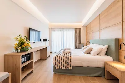 a hotel room with a bed and a television at Acandia Hotel in Rhodes Town