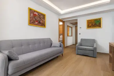 a living room with a couch and a chair at Acandia Hotel in Rhodes Town