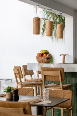 a dining room with chairs and a table with a bowl of fruit at Acandia Hotel in Rhodes Town
