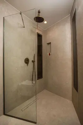 a shower with a glass door in a bathroom at Ladiko Suites - Faliraki in Faliraki