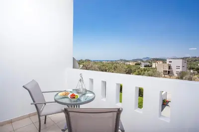 a table and chairs on a balcony with a view at La Casa Del Amor in Kalithies
