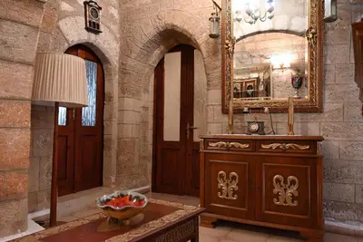 a bathroom with a wooden dresser and a mirror at Megiston House in Old Town Rhodes in Rhodes Town