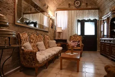 a living room with a couch and two chairs at Megiston House in Old Town Rhodes in Rhodes Town