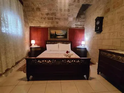 a bedroom with a large bed in a room with two lamps at Megiston House in Old Town Rhodes in Rhodes Town