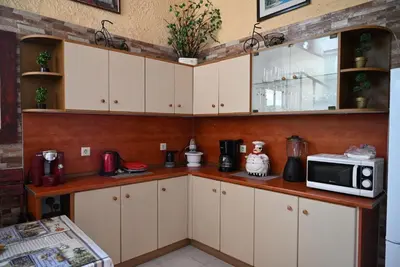 a kitchen with white cabinets and a microwave at Megiston House in Old Town Rhodes in Rhodes Town