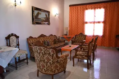 a living room with couches and chairs and a table at Megiston House in Old Town Rhodes in Rhodes Town