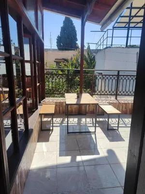 a porch with benches on a balcony at Megiston House in Old Town Rhodes in Rhodes Town
