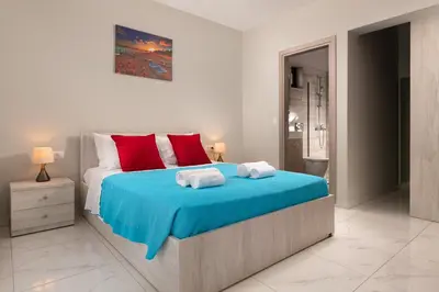 a bedroom with a bed with two towels on it at Villa Divina in Kremasti