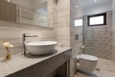 a bathroom with a bowl sink and a toilet at Villa Divina in Kremasti