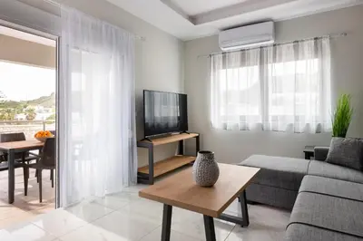 a living room with a couch and a tv at Villa Divina in Kremasti