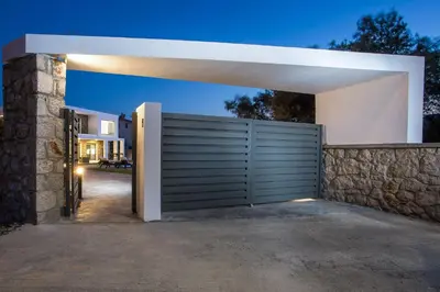 a gate to a house with a stone wall at Modern Villa with Pool & Garden Kastalys, Rhodes in Kalithies