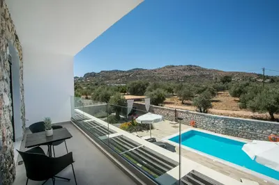 a view from the balcony of a house with a swimming pool at Modern Villa with Pool & Garden Kastalys, Rhodes in Kalithies