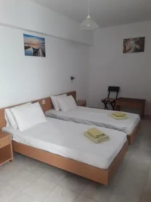 a room with two beds with towels on them at PHILIPPOS STUDIOS & APT in Líndos
