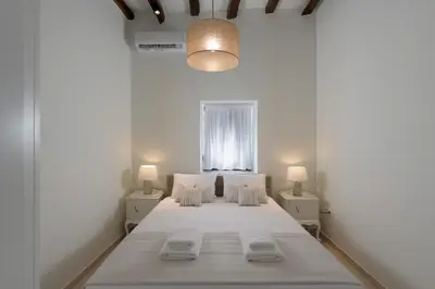 a bedroom with a bed and two night stands at Kite Blue Villas in Kattavía