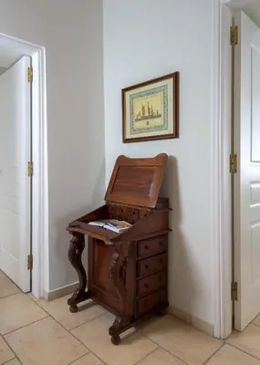 a wooden piano in a room with a picture on the wall at Kite Blue Villas in Kattavía