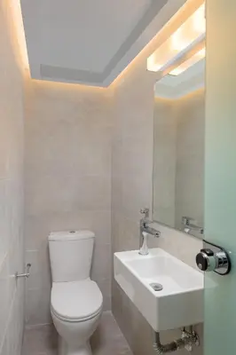 a bathroom with a white toilet and a sink at Kite Blue Villas in Kattavía