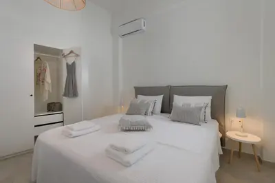 a bedroom with a white bed with towels on it at Kite Blue Villas in Kattavía