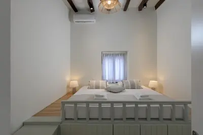 a bedroom with a large bed in a white room at Kite Blue Villas in Kattavía