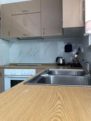 a kitchen with a sink and a wooden counter top at Chrysanthi’s in Faliraki