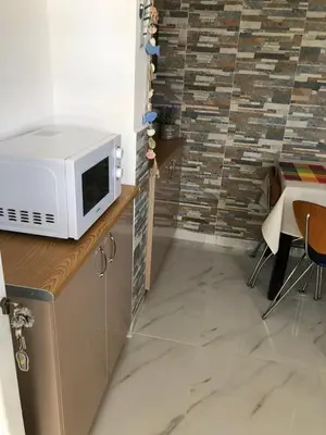 a kitchen with a microwave on top of a counter at Chrysanthi’s in Faliraki