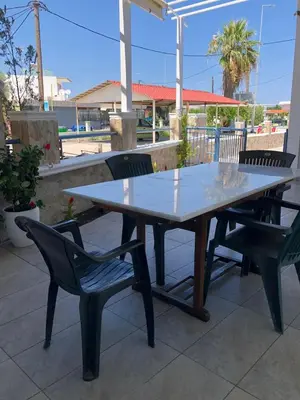 a table and chairs sitting on a patio at Chrysanthi’s in Faliraki