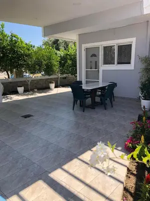 a patio with a table and chairs on it at Chrysanthi’s in Faliraki