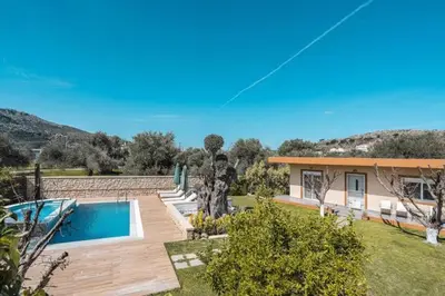 a villa with a swimming pool and a house at Villa MATA - 600m² with Private Pool and Jacuzzi in Kalithies