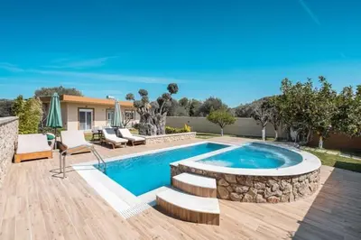 a backyard with a swimming pool and a house at Villa MATA - 600m² with Private Pool and Jacuzzi in Kalithies