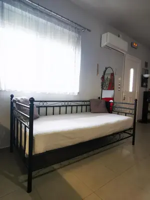 a metal bed in a room with a window at Villa MATA - 600m² with Private Pool and Jacuzzi in Kalithies