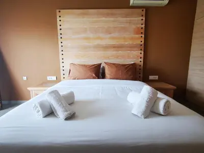 a white bed with three pillows on it at Villa MATA - 600m² with Private Pool and Jacuzzi in Kalithies