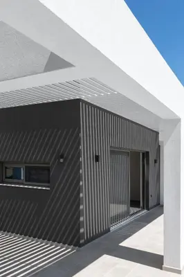 a black and white building with a white roof at Armonia Suites in Gennadi
