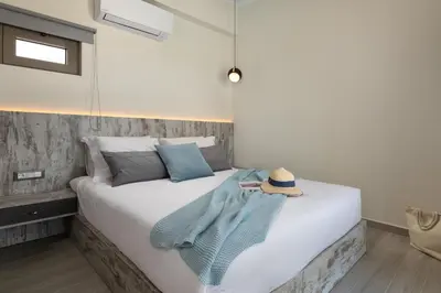 a bedroom with a bed with a hat on it at Armonia Suites in Gennadi
