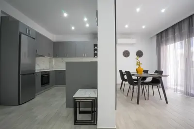 a kitchen and dining room with a table and chairs at Rodini House in Rhodes Town