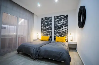 a bedroom with a bed and two yellow pillows at Rodini House in Rhodes Town
