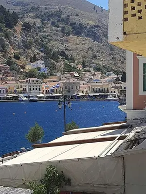 a view of a town and a body of water at Harbour View Apartment in Symi
