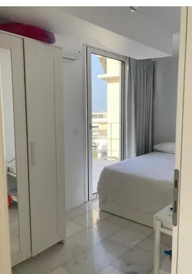 a bedroom with a bed and a large window at Panoramic view - Penthouse in Rhodes Town
