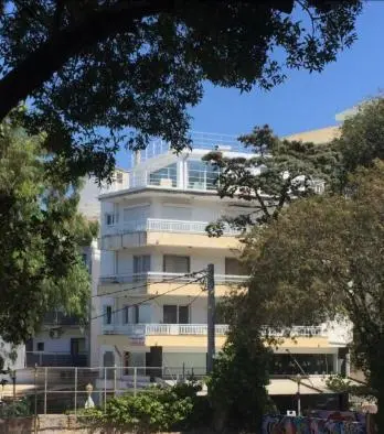 a large white building in front of a building at Panoramic view - Penthouse in Rhodes Town