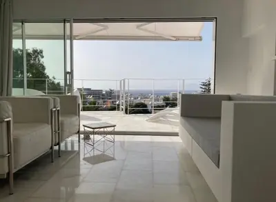 a living room with chairs and a large window at Panoramic view - Penthouse in Rhodes Town