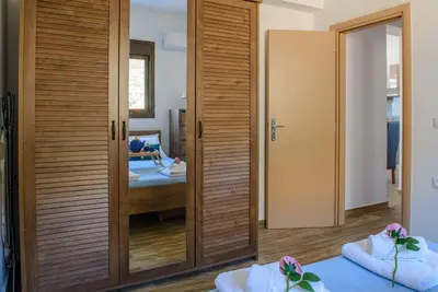 a room with a door and a bedroom with a bed at Blue Bay Villas , Ground Floor in Archangelos