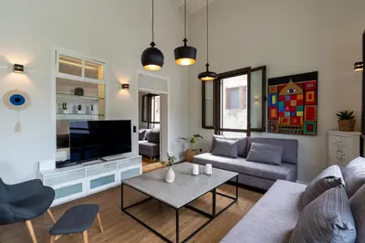 a living room with a couch and a tv at Letty's House - Old Town Luxury Mansion in Rhodes Town
