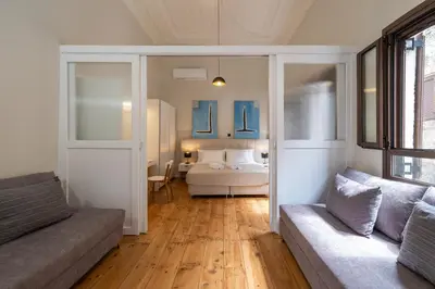 a living room with a bed and a couch at Letty's House - Old Town Luxury Mansion in Rhodes Town