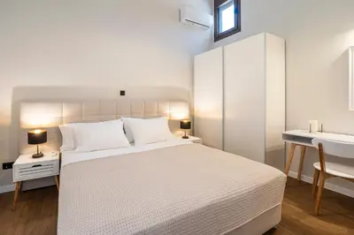 a white bedroom with a white bed and a sink at Letty's House - Old Town Luxury Mansion in Rhodes Town