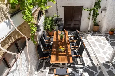 an overhead view of a wooden table and chairs at Letty's House - Old Town Luxury Mansion in Rhodes Town